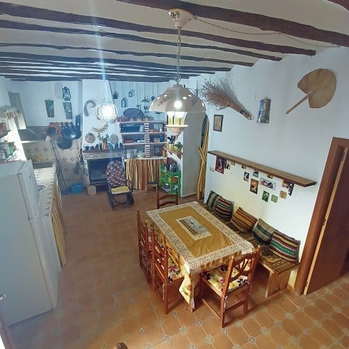 Charming interior of a village property in Fontanar, Jaen, featuring rustic decor, wooden beams, and.