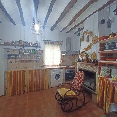 Charming village kitchen with rustic decor, exposed wooden beams, and traditional accents in Fontana.