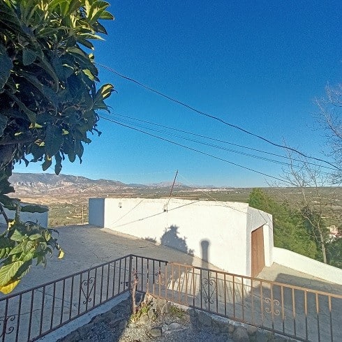Scenic view of Fontanar village with white house and mountain backdrop in Jaen, Spain.