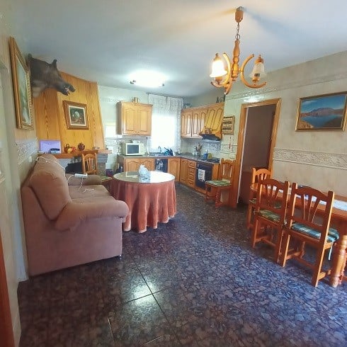 Charming village home in Fontanar, Jaen with cozy living area, traditional kitchen, and rustic decor.