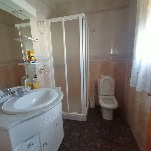 Bright bathroom with shower, sink, and toilet in Fontanar village, Jaen. Perfect for comfortable liv.