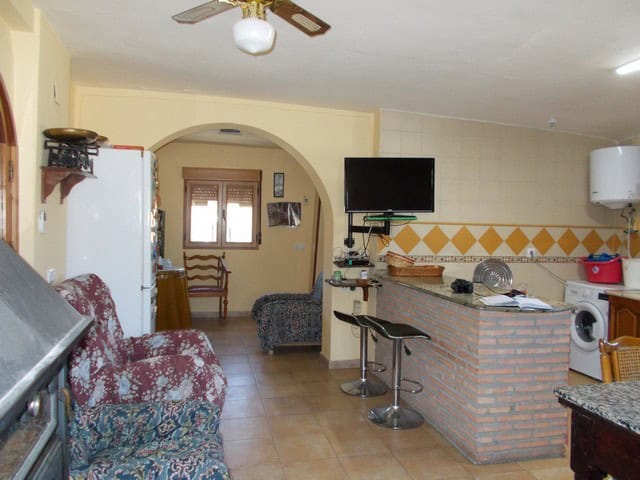 Cozy interior of a rural home in Seron, Almeria, featuring a living area, kitchen, and modern applia.