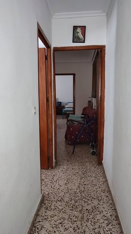 Interior view of a town house in Caniles, Granada, showcasing a hallway with a walker and living are.