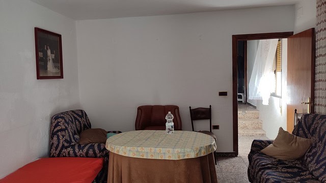 Interior view of a town house in Caniles, Granada with cozy living room furniture.