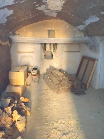 Cave house interior with natural rock walls and rustic furnishings in Benamaurel, Granada. Unique un.