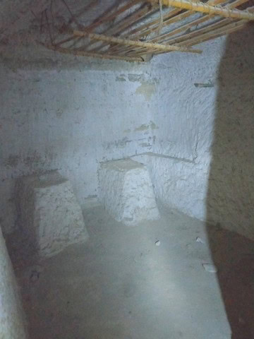 Authentic cave dwelling interior in Benamaurel, Granada, showcasing rustic stone walls and unique ar.