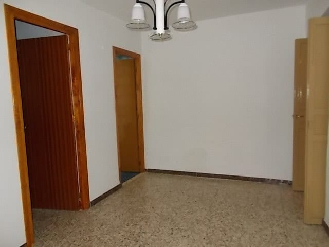 Interior view of a village property in Somontin, Almeria, showcasing a simple, clean room with white.