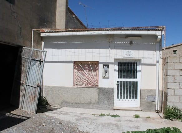 Traditional rural house in Tijola, Almeria, with white exterior walls and a secure gate. Perfect for.