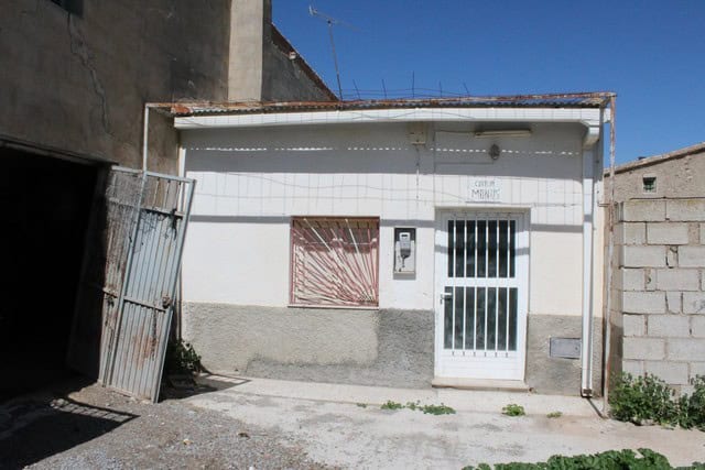 Traditional rural house in Tijola, Almeria, with white exterior walls and a secure gate. Perfect for.