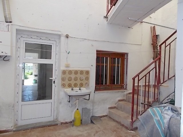 Charming rural home exterior with stairs and window in Tijola, Almeria, ideal for countryside living.