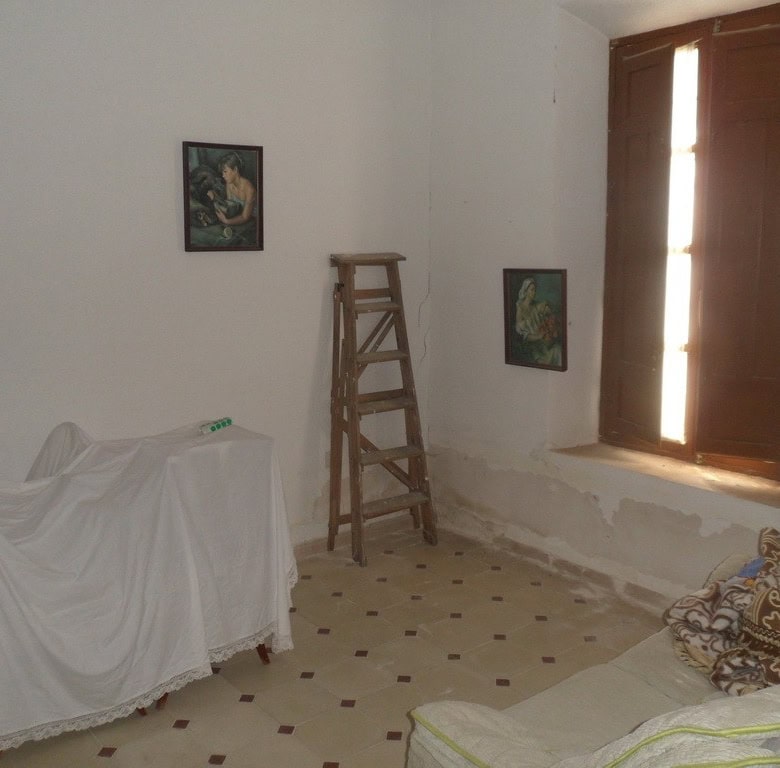 Village property interior with rustic furniture and natural light in Campo Camara, Granada.