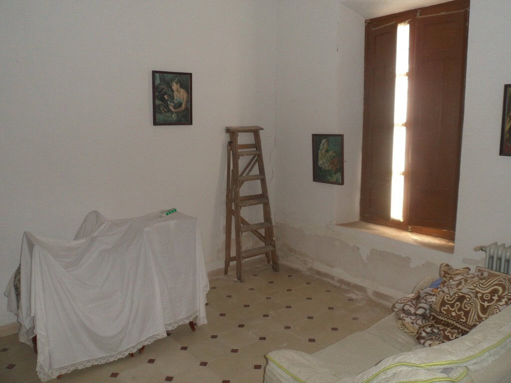 Village property interior with rustic furniture and natural light in Campo Camara, Granada.