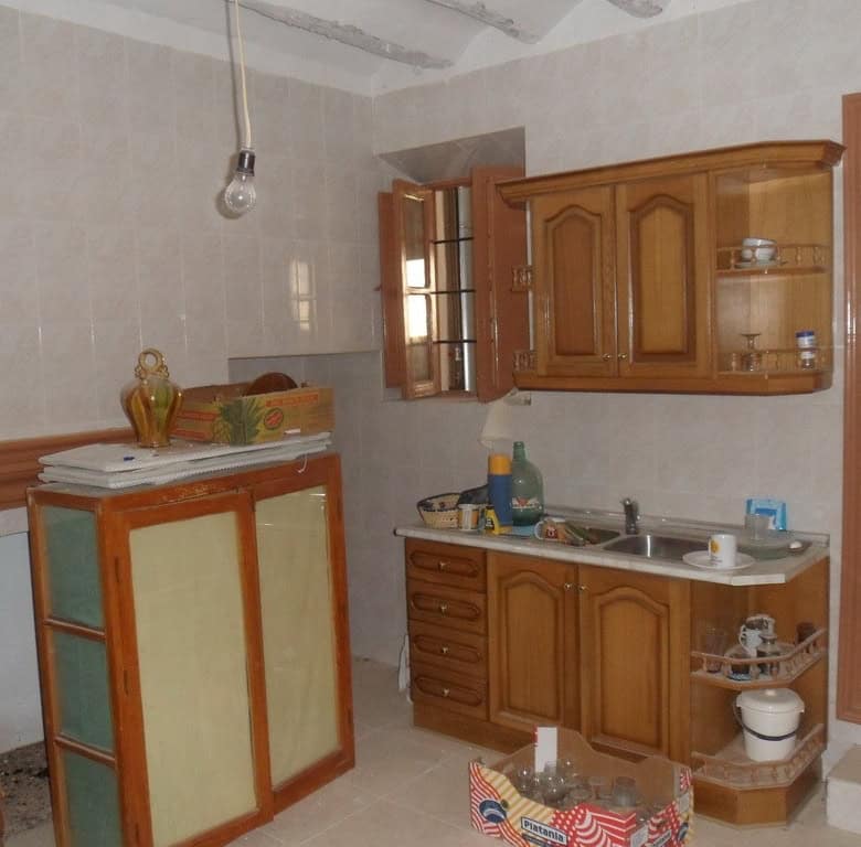 Charming kitchen in a village property located in Campo Camara, Granada, featuring wooden cabinets a.