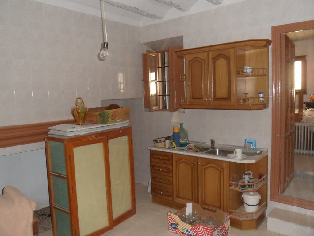 Charming kitchen in a village property located in Campo Camara, Granada, featuring wooden cabinets a.