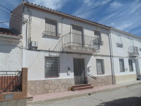 Charming village house in Campo Camara, Granada, with traditional architecture and outdoor balcony.