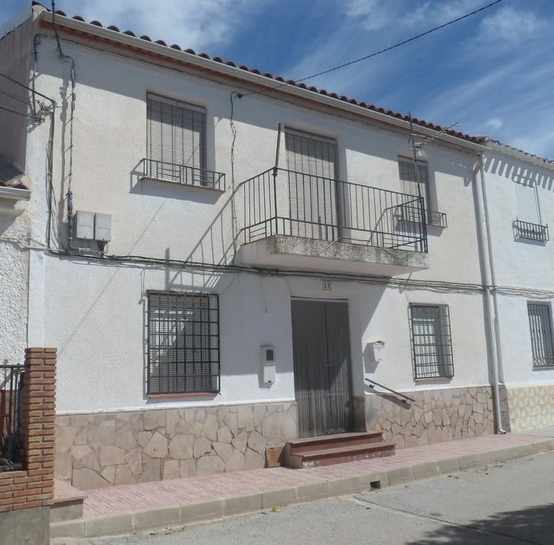 Charming village house in Campo Camara, Granada, with traditional architecture and outdoor balcony.