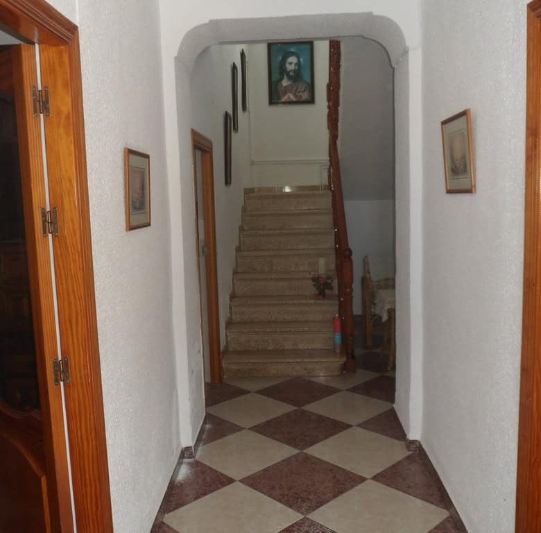 Cozy interior view of a village home in Campo Camara, Granada, featuring a staircase and traditional.