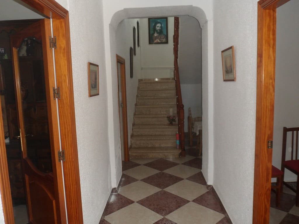 Cozy interior view of a village home in Campo Camara, Granada, featuring a staircase and traditional.