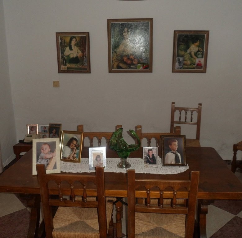 Charming village property in Campo Camara, Granada, featuring a cozy interior with family photos and.