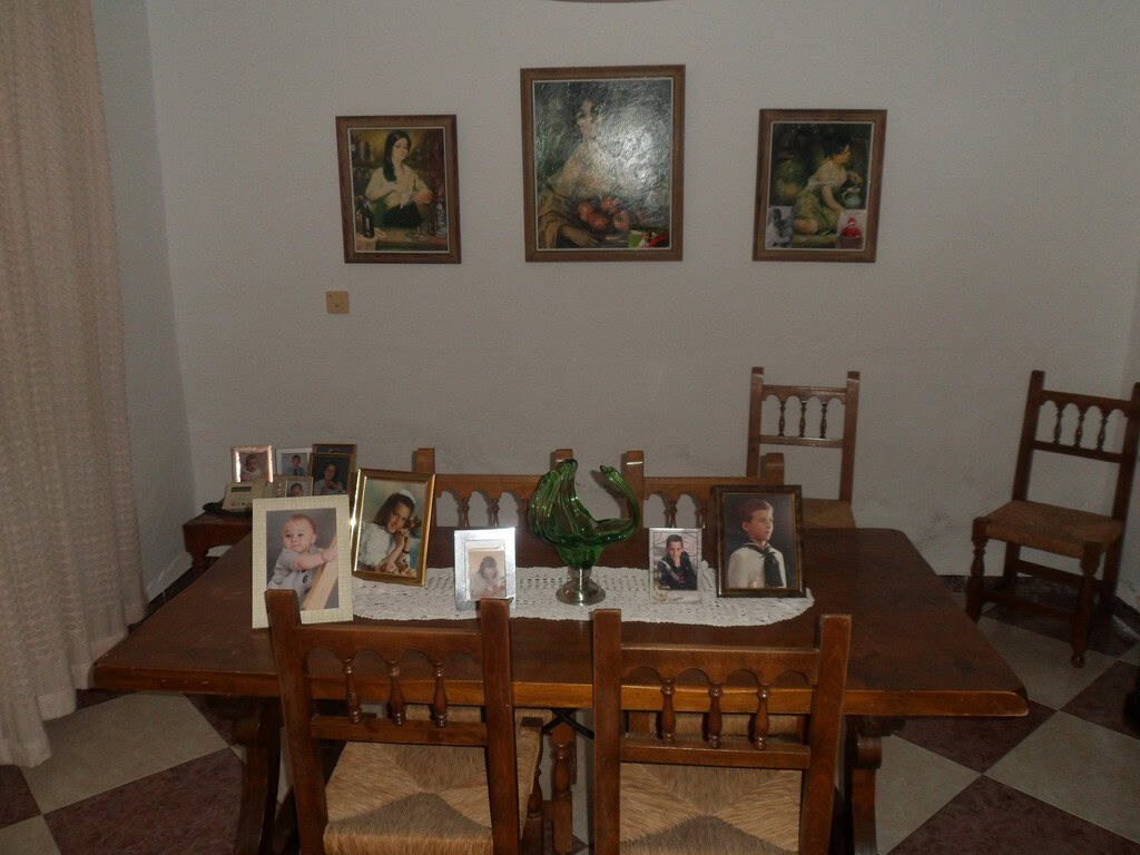Charming village property in Campo Camara, Granada, featuring a cozy interior with family photos and.