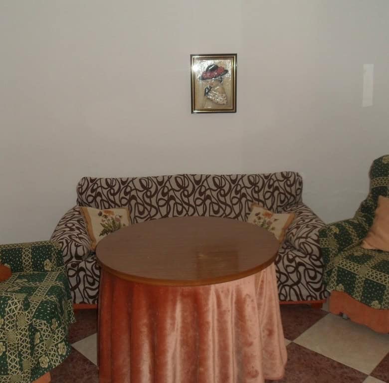 Charming village property in Campo Camara, Granada, featuring a cozy living room with patterned sofa.