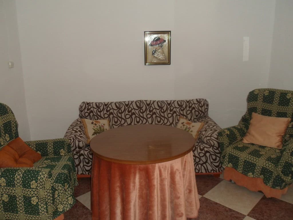 Charming village property in Campo Camara, Granada, featuring a cozy living room with patterned sofa.