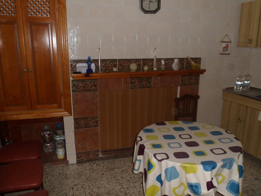 Charming village property in Campo Camara, Granada, featuring a cozy interior with wooden furniture.