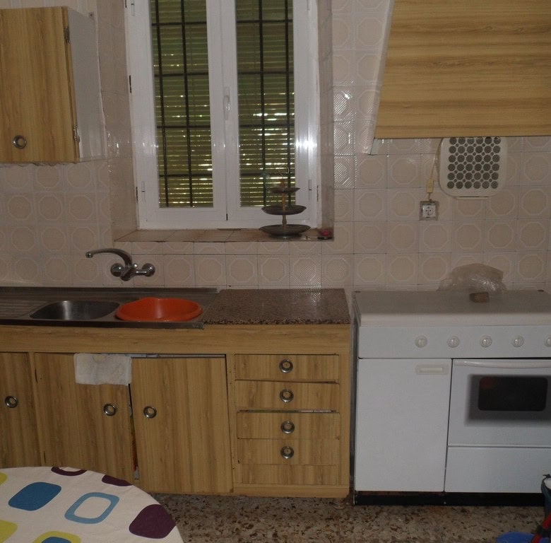 Charming village property in Campo Camara, Granada, featuring a cozy kitchen with wooden cabinets an.