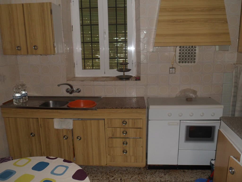 Charming village property in Campo Camara, Granada, featuring a cozy kitchen with wooden cabinets an.