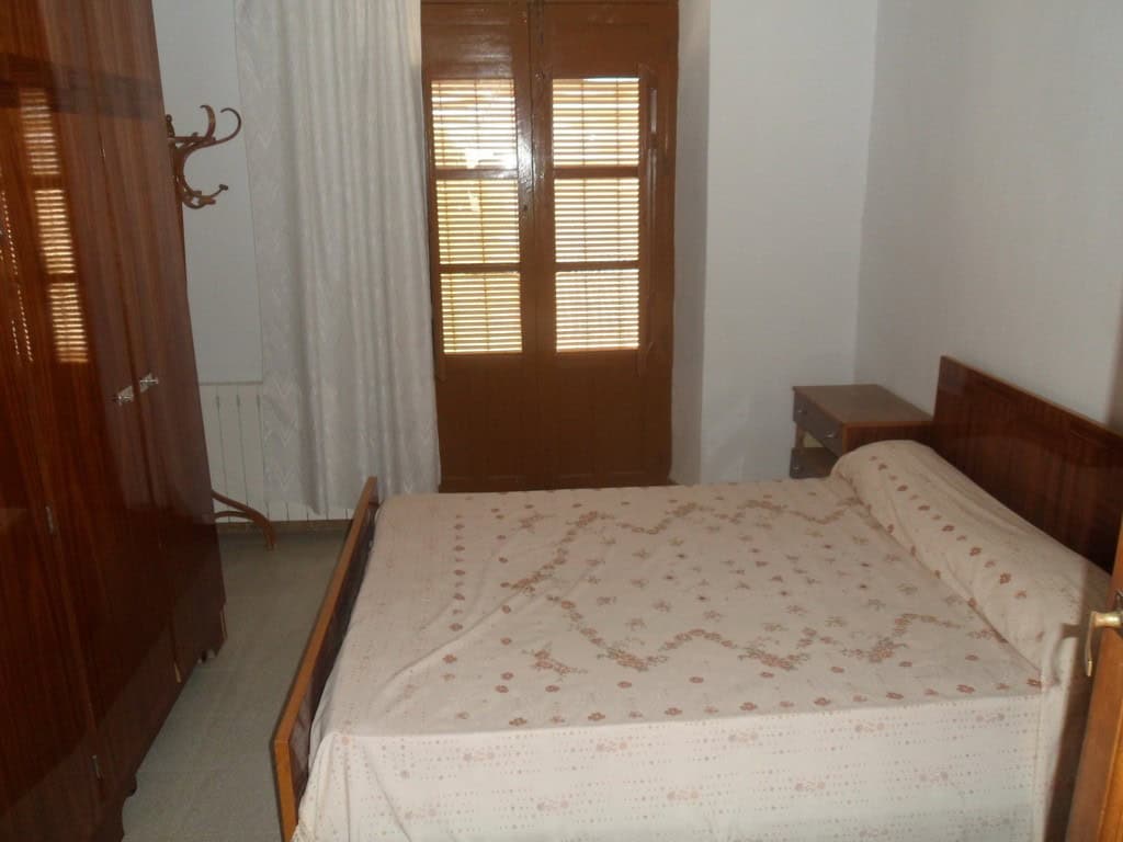 Charming bedroom in a village property in Campo Camara, Granada, featuring wooden furniture and natu.