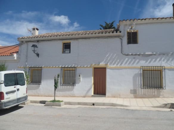 Charming village house in Campo Camara, Granada, with traditional white exterior and rustic charm.