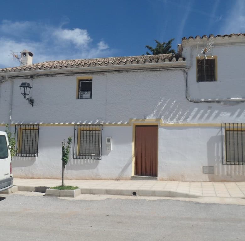 Charming village house in Campo Camara, Granada, with traditional white exterior and rustic charm.