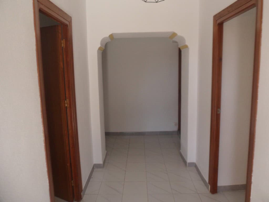 Village property entrance in Campo Camara, Granada with white walls and wooden door frames.