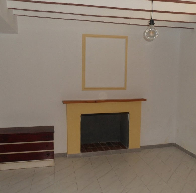 Cozy living room with fireplace in a traditional village property in Campo Camara, Granada. Ideal fo.