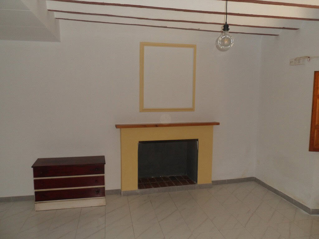 Cozy living room with fireplace in a traditional village property in Campo Camara, Granada. Ideal fo.