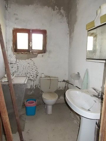 Charming rustic bathroom in a rural property in Lucar, Almeria, featuring a simple toilet and sink w.