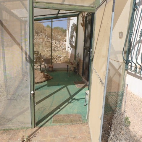 Rural property entrance with glass enclosure in Chirivel, Almeria.