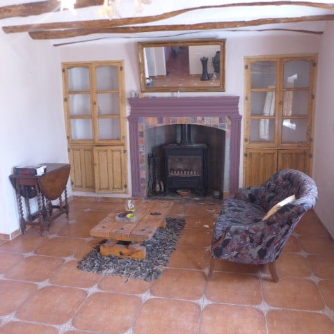Chirivel rural home interior with cozy fireplace and traditional decor.