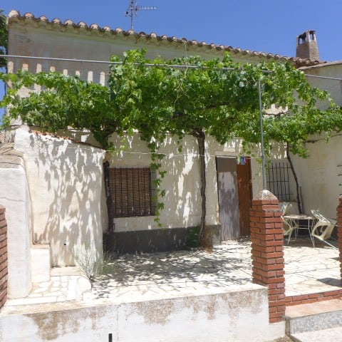 Grape vine provides shade to a charming village property in Chirivel, Almeria, ideal for outdoor rel.