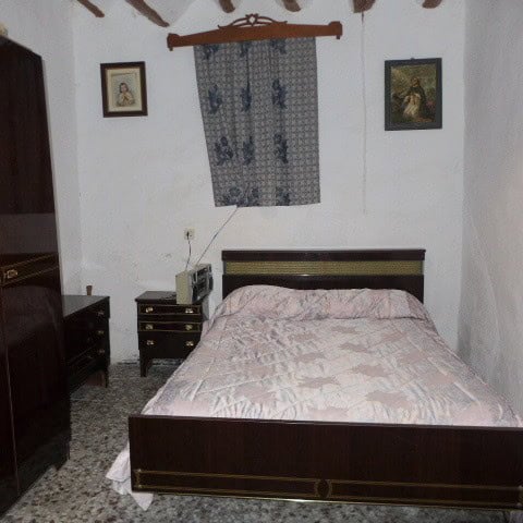 Chirivel village property bedroom with simple decor and traditional furnishings.