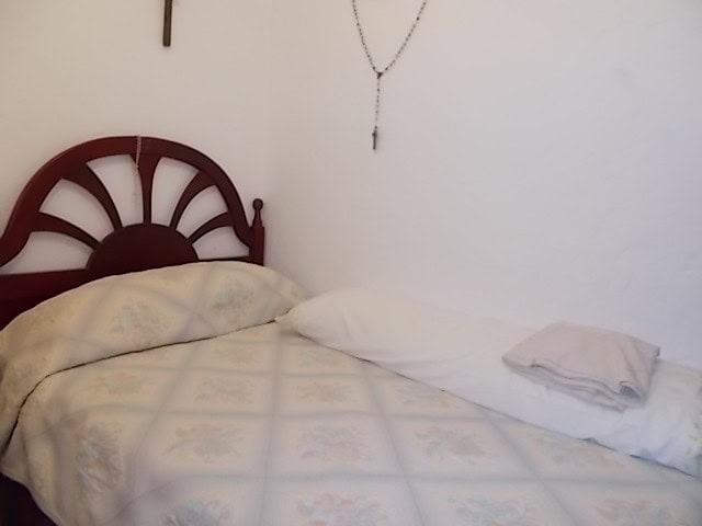Cozy bedroom in rural property in Seron, Almeria, with simple decor and white walls.