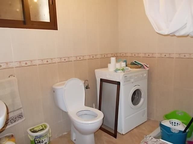 Rural property bathroom with washing machine in Seron, Almeria.