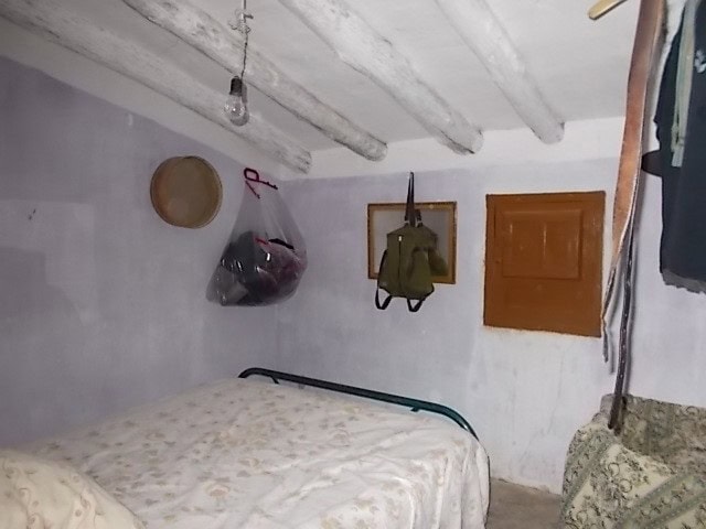 Interior of a rustic rural property in Seron, Almeria, showing simple furnishings and storage items.