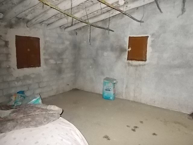 Interior of unfinished rural property in Seron, Almeria, with concrete walls and exposed ceiling bea.