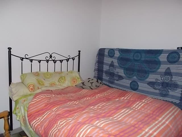 Cozy bedroom with colorful bedding and simple decor in a rural property in Purchena, Almeria.