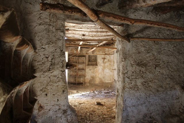 Abandoned rustic building in Lucar, Almeria, with exposed wooden beams and stone walls.