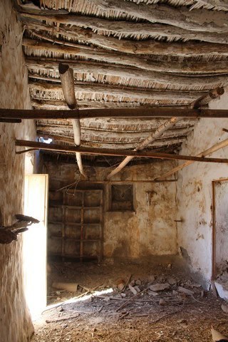 Traditional rustic interior in Lucar, Almeria, showcasing aged wooden beams and simple construction.