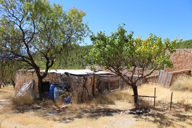 Charming rural property in Lucar, Almeria with rustic structures and natural surroundings.