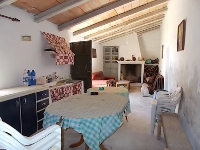 Charming interior of a rural property in Lucar, Almeria, featuring a rustic kitchen and living area.