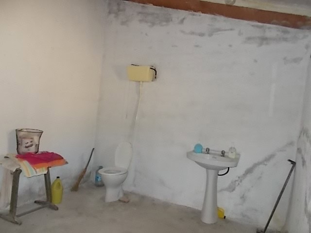 Rural property in Lucar, Almeria, featuring a basic bathroom with toilet and sink in a rustic settin.